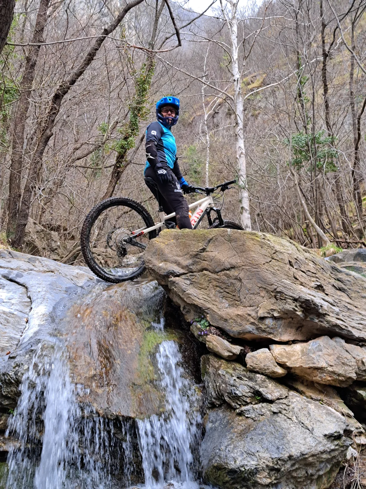 Rider beside a woodland waterfall