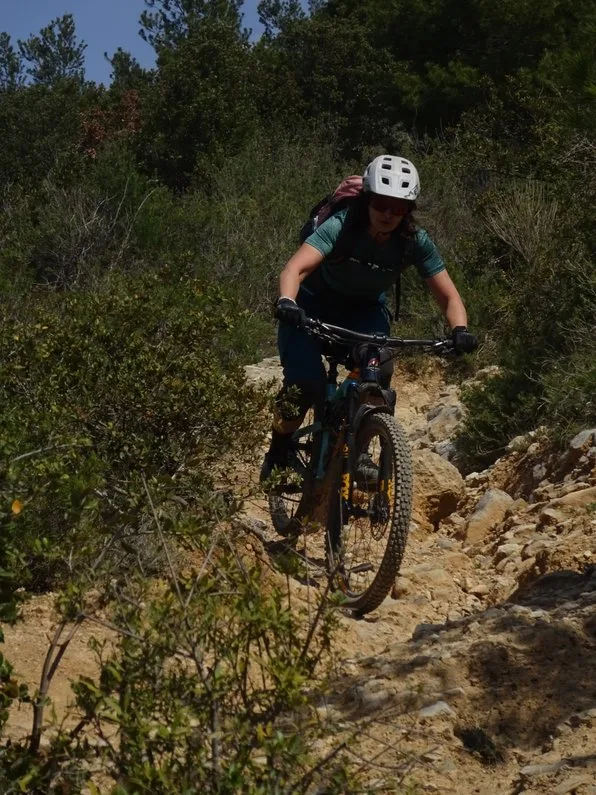 Rider on a singletrack through shrubs